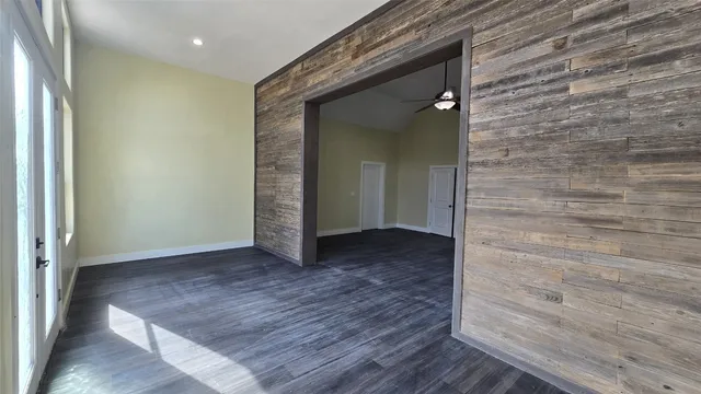 an empty room with wooden floor and closet