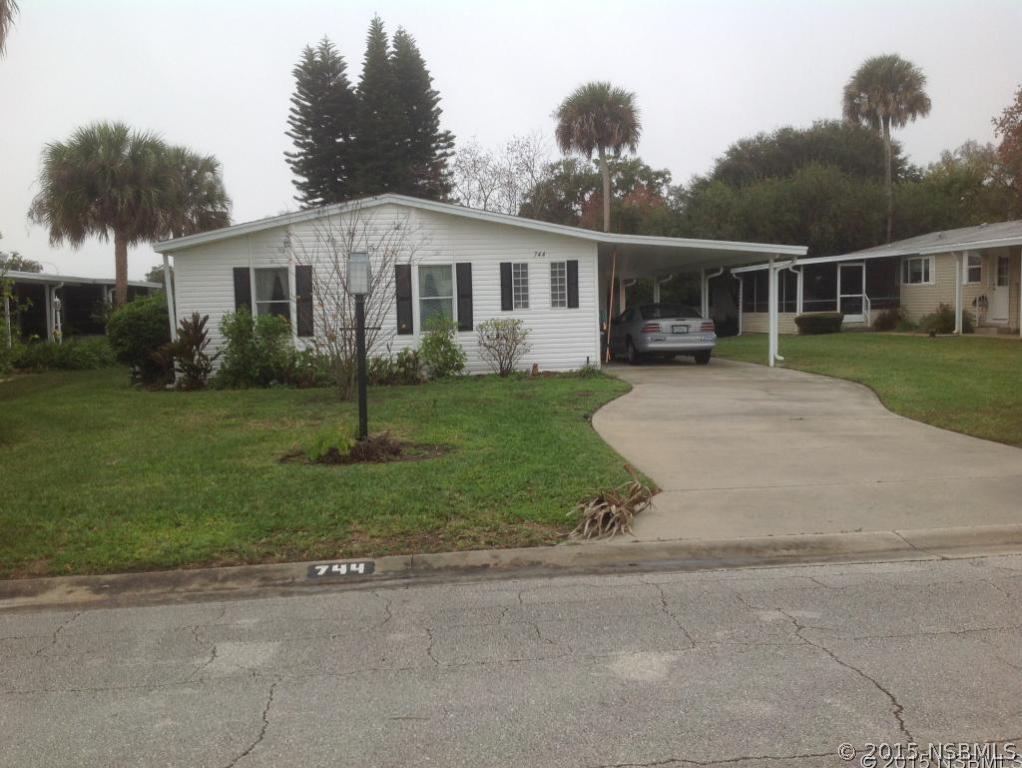 a front view of house with a garden and patio