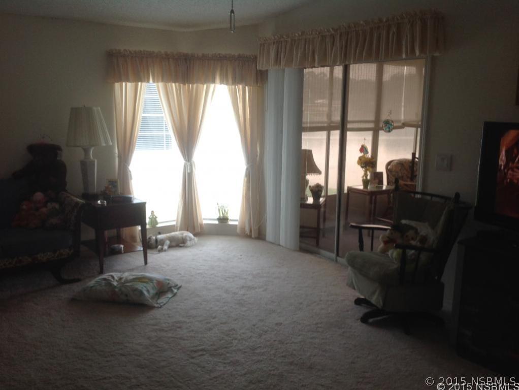 744 Navigators Way Edgewater, FL 32141 - Photo 3 of 6 a view of a room with furniture and a window