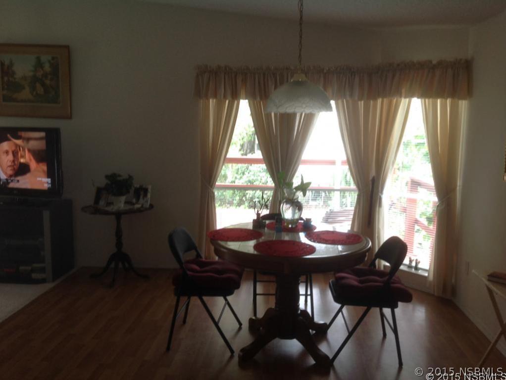 744 Navigators Way Edgewater, FL 32141 - Photo 4 of 6 a view of a dining room with furniture and window