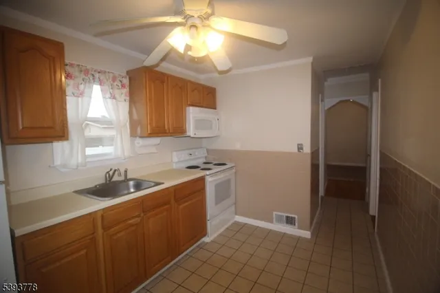 a kitchen with a sink cabinets and window