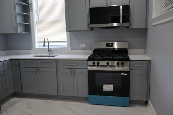 a kitchen with a sink and stainless steel appliances