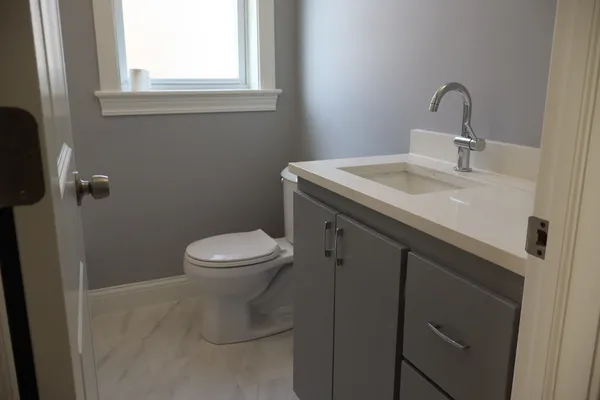 a bathroom with a light fixture and a window