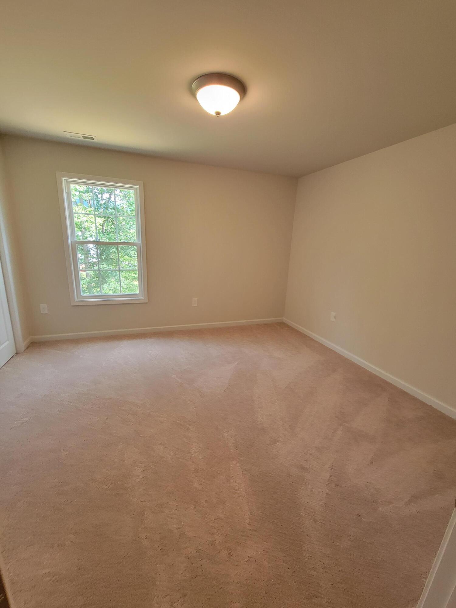 4933 Warrior Drive Salem, VA 24153 - Photo 11 of 11 an empty room with a empty space and windows