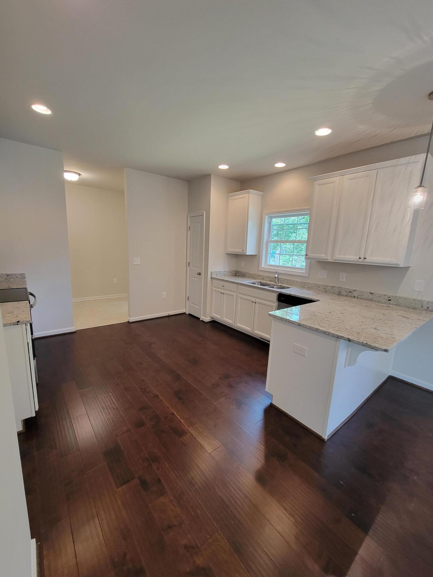 4933 Warrior Drive Salem, VA 24153 - Photo 3 of 11 an open kitchen with kitchen island white cabinets and counter space