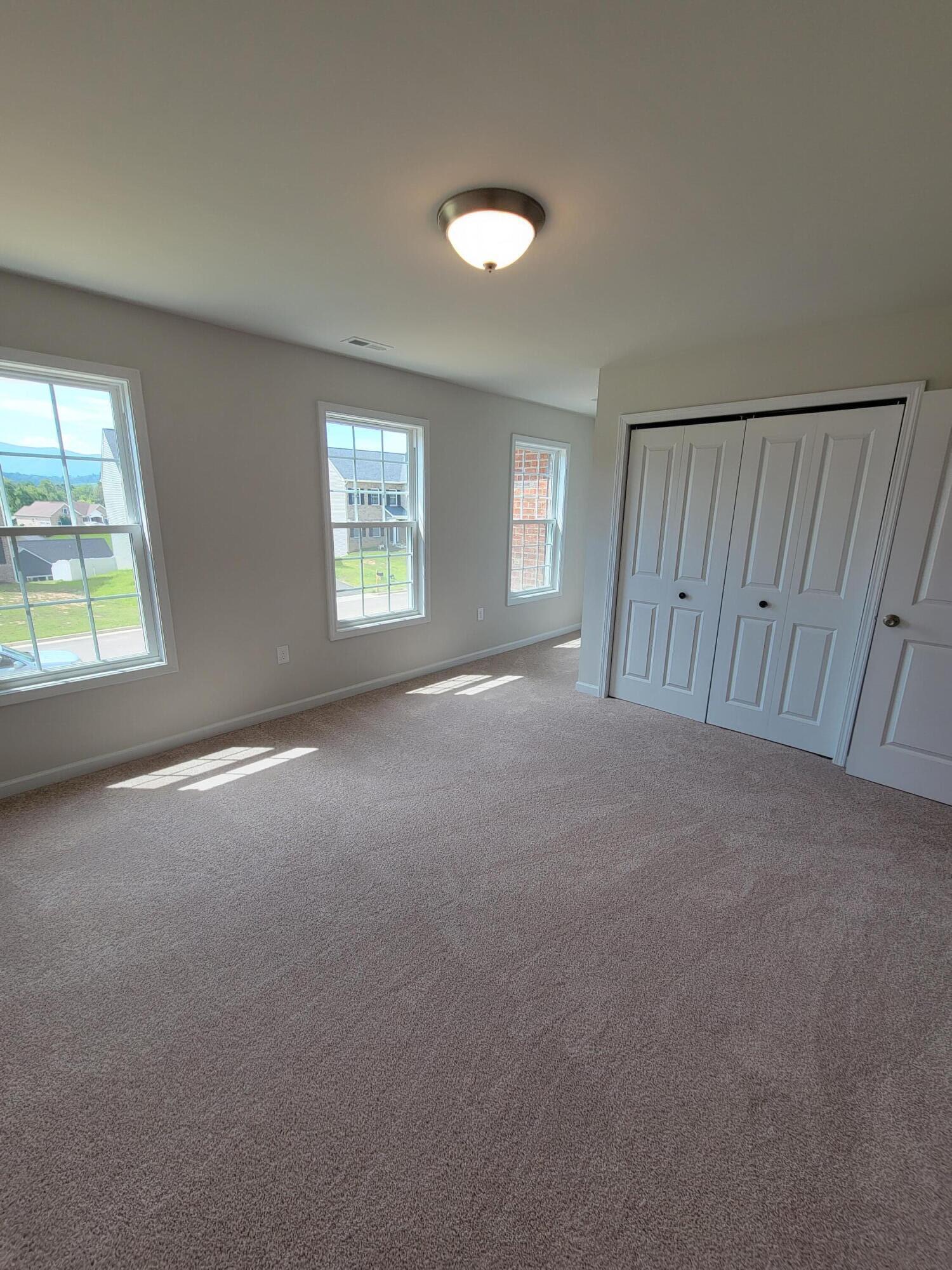 4933 Warrior Drive Salem, VA 24153 - Photo 10 of 11 an empty room with windows and closet