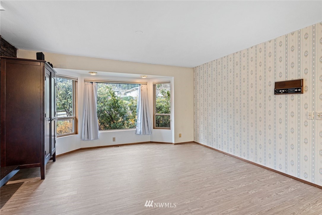 16418 Southeast 145th Street Renton, WA 98059 - Photo 11 of 25 a view of an empty room with wooden floor and a window