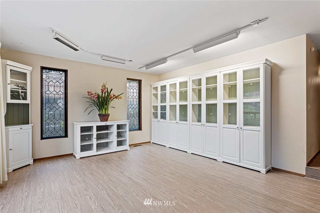 16418 Southeast 145th Street Renton, WA 98059 - Photo 12 of 25 an empty room with wooden floor and windows