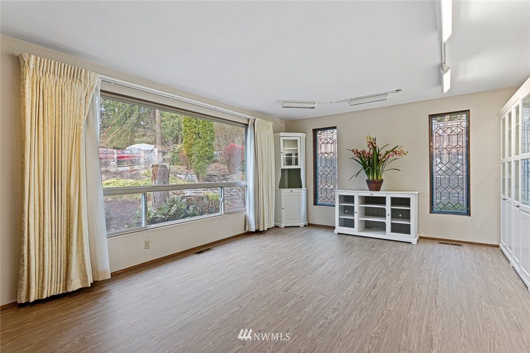 16418 Southeast 145th Street Renton, WA 98059 - Photo 13 of 25 an empty room with wooden floor and windows