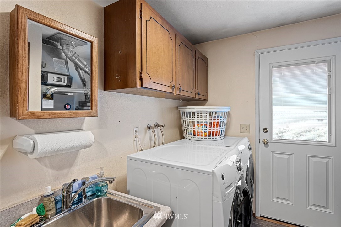 16418 Southeast 145th Street Renton, WA 98059 - Photo 15 of 25 a utility room with a sink a washer and dryer
