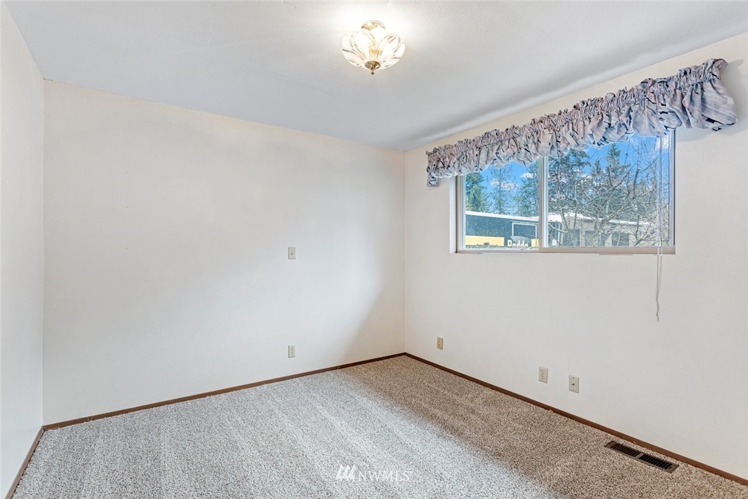 16418 Southeast 145th Street Renton, WA 98059 - Photo 20 of 25 a view of an empty room with a window