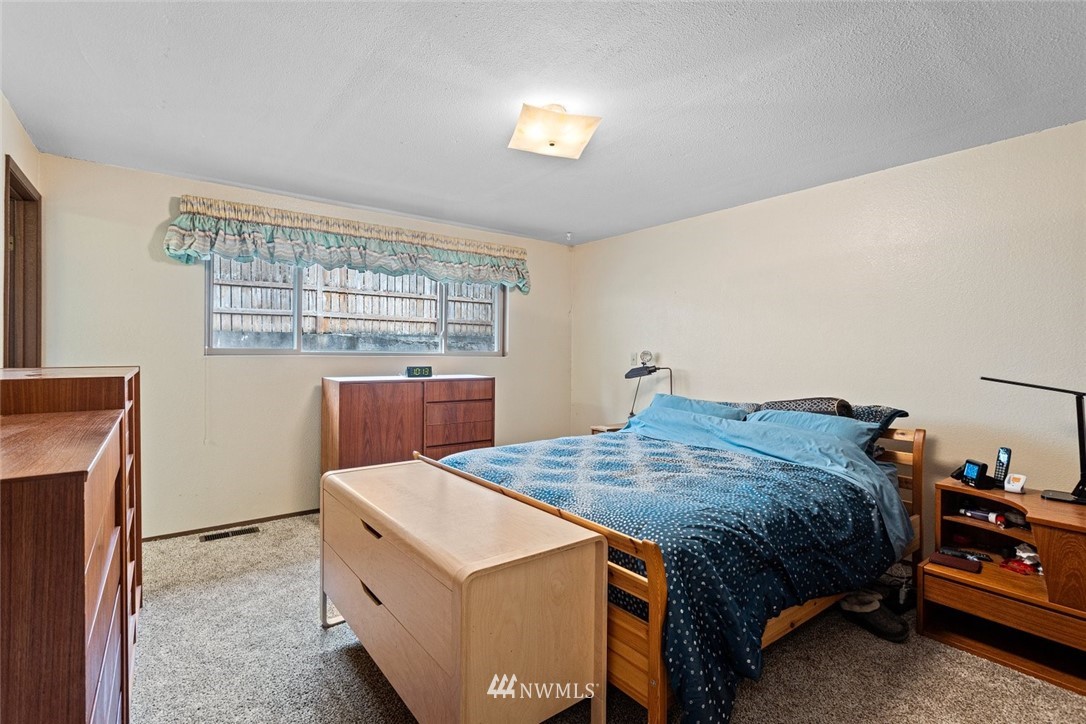 16418 Southeast 145th Street Renton, WA 98059 - Photo 21 of 25 a bedroom with a bed and a window