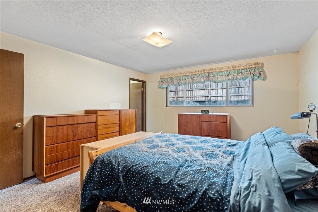16418 Southeast 145th Street Renton, WA 98059 - Photo 22 of 25 a bedroom with a bed and a cabinets