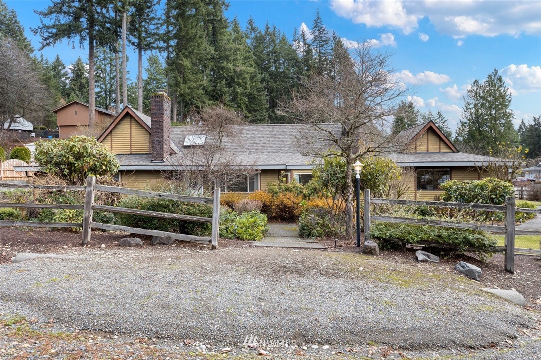 16418 Southeast 145th Street Renton, WA 98059 - Photo 23 of 25 a front view of a house with a yard and shrubs