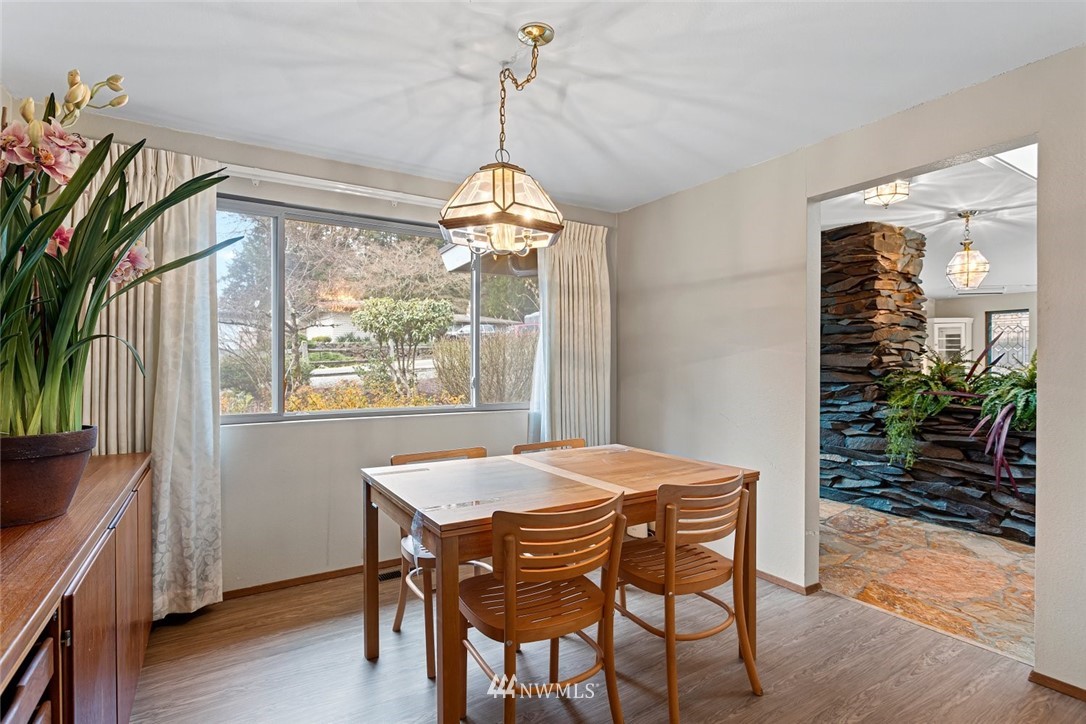16418 Southeast 145th Street Renton, WA 98059 - Photo 6 of 25 a view of a dining room with furniture window and wooden floor