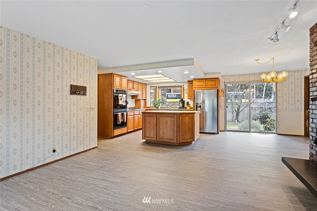16418 Southeast 145th Street Renton, WA 98059 - Photo 7 of 25 a large white kitchen with a large window