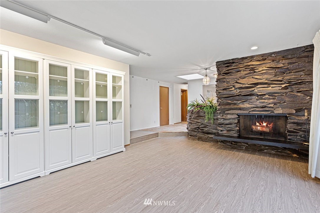 16418 Southeast 145th Street Renton, WA 98059 - Photo 10 of 25 an empty room with furniture and a fireplace