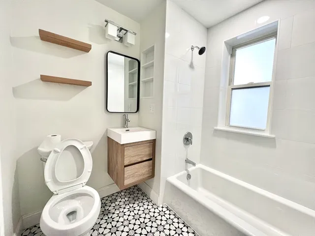 a bathroom with a toilet a sink and bathtub