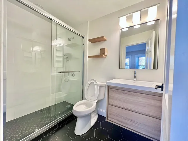 a bathroom with a toilet sink and shower