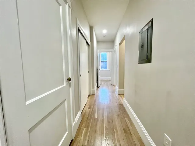 a view of a hallway with wooden floor