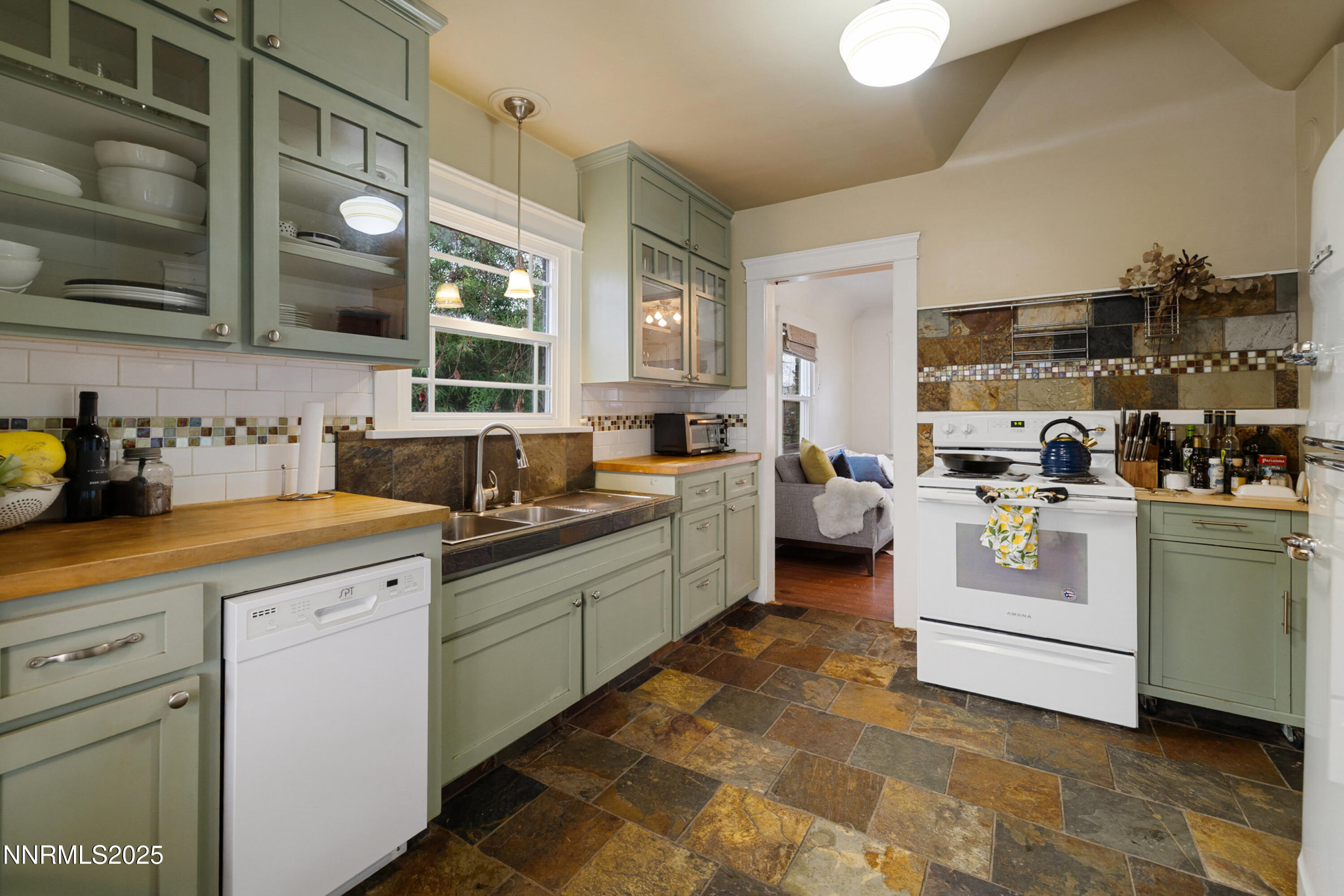 948 Washington Street Reno, NV 89503 - Photo 13 of 29 a kitchen with white cabinets and white appliances