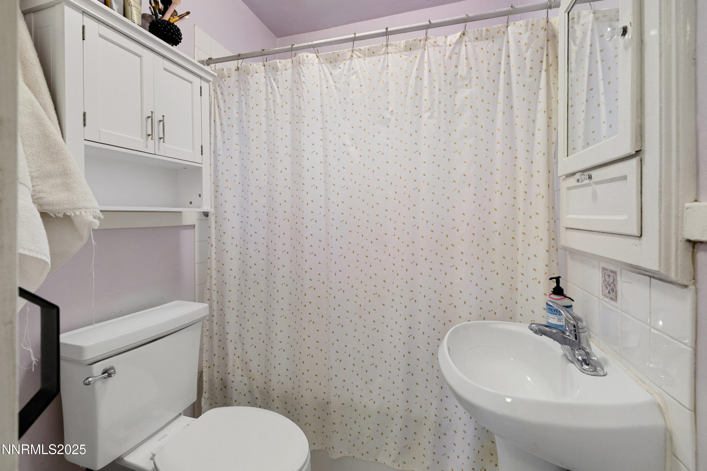 948 Washington Street Reno, NV 89503 - Photo 16 of 29 a bathroom with a sink a toilet and shower curtain