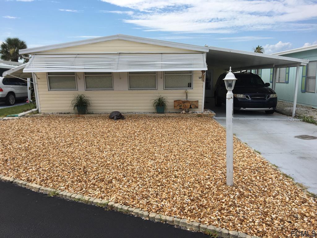 a front view of a house with parking space