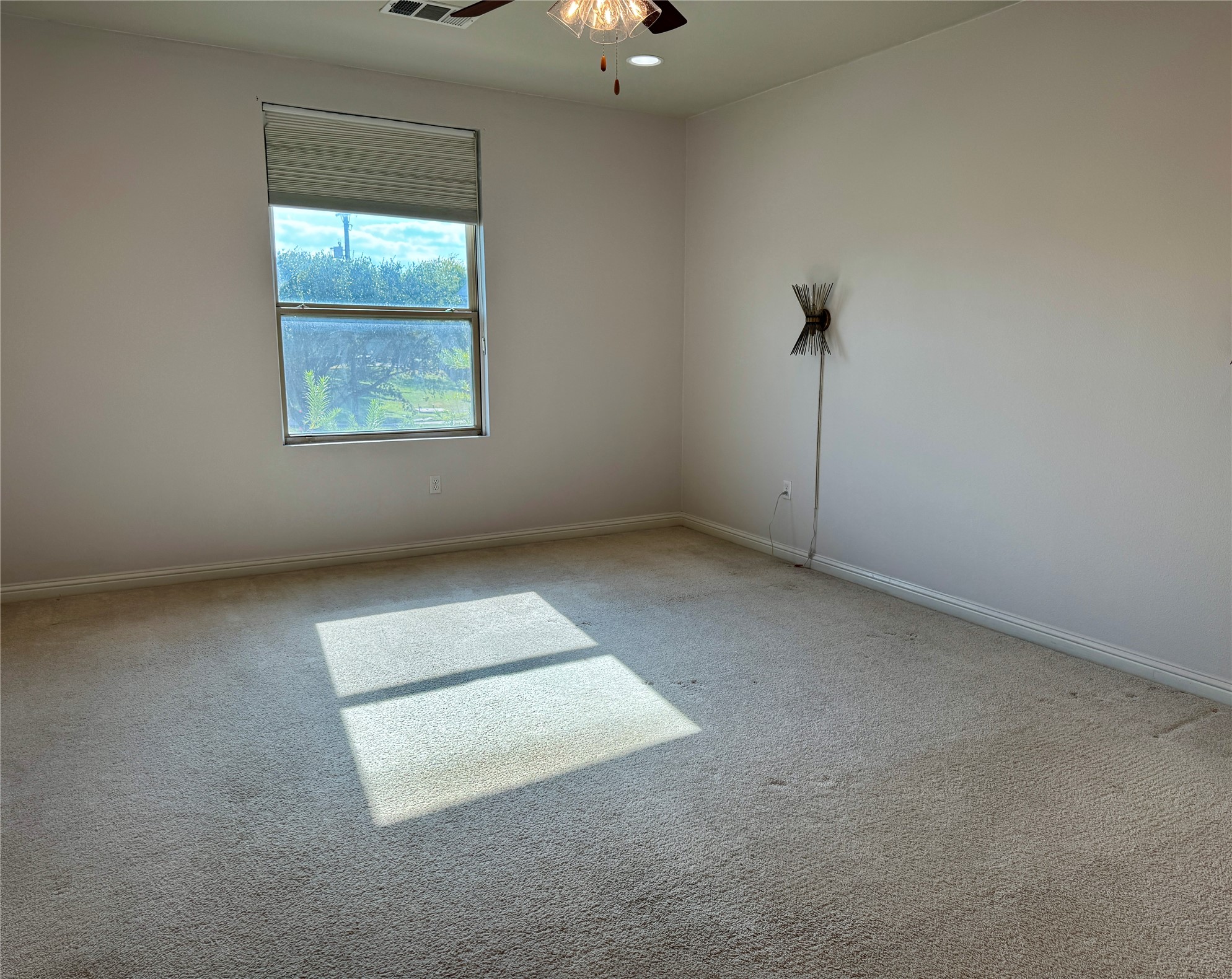 6814 East Riverside Drive, Unit 25 Austin, TX 78741 - Photo 12 of 26 Empty room with carpet flooring and a ceiling fan
