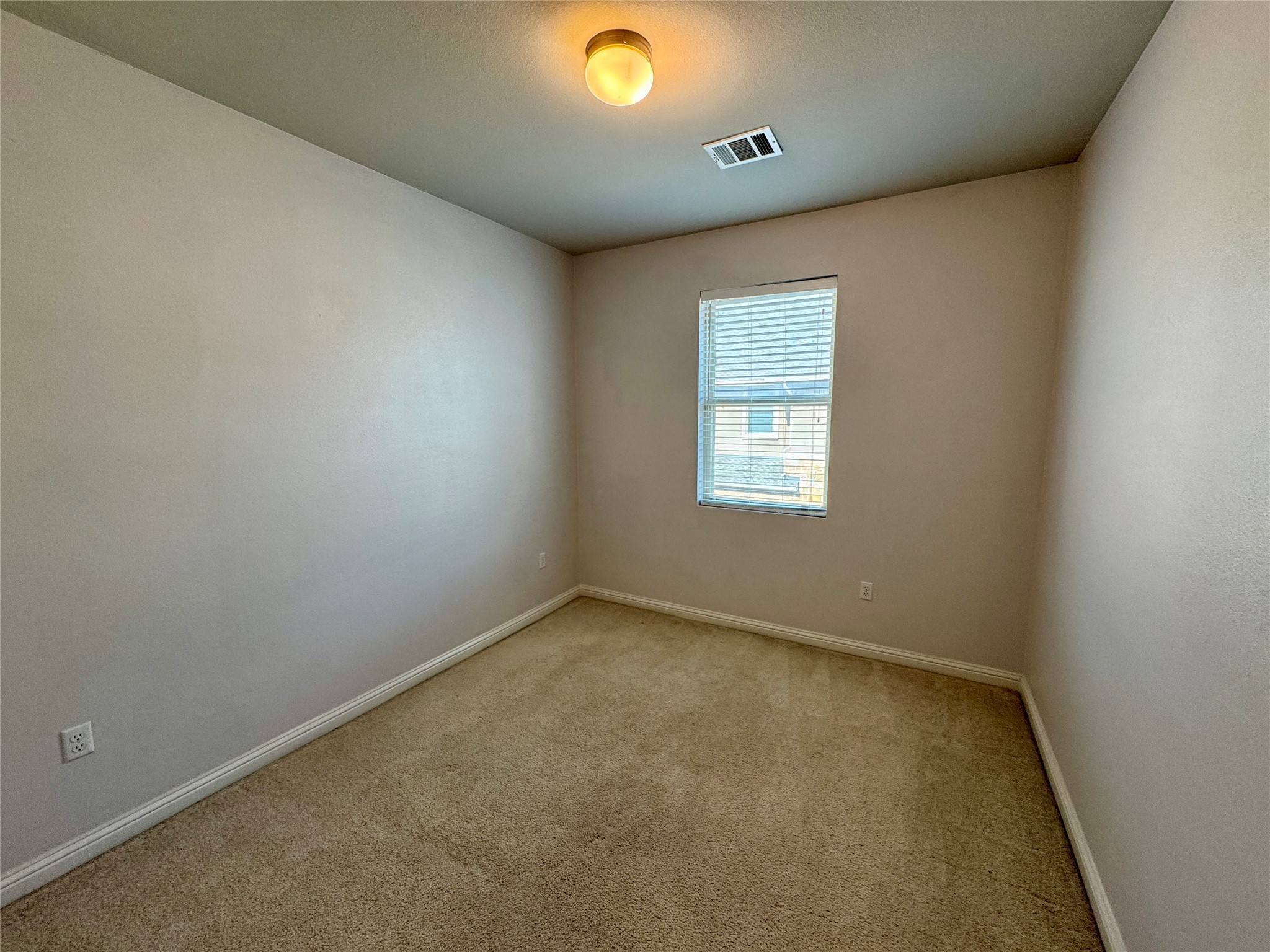 6814 East Riverside Drive, Unit 25 Austin, TX 78741 - Photo 18 of 26 Empty room with carpet floors and baseboards