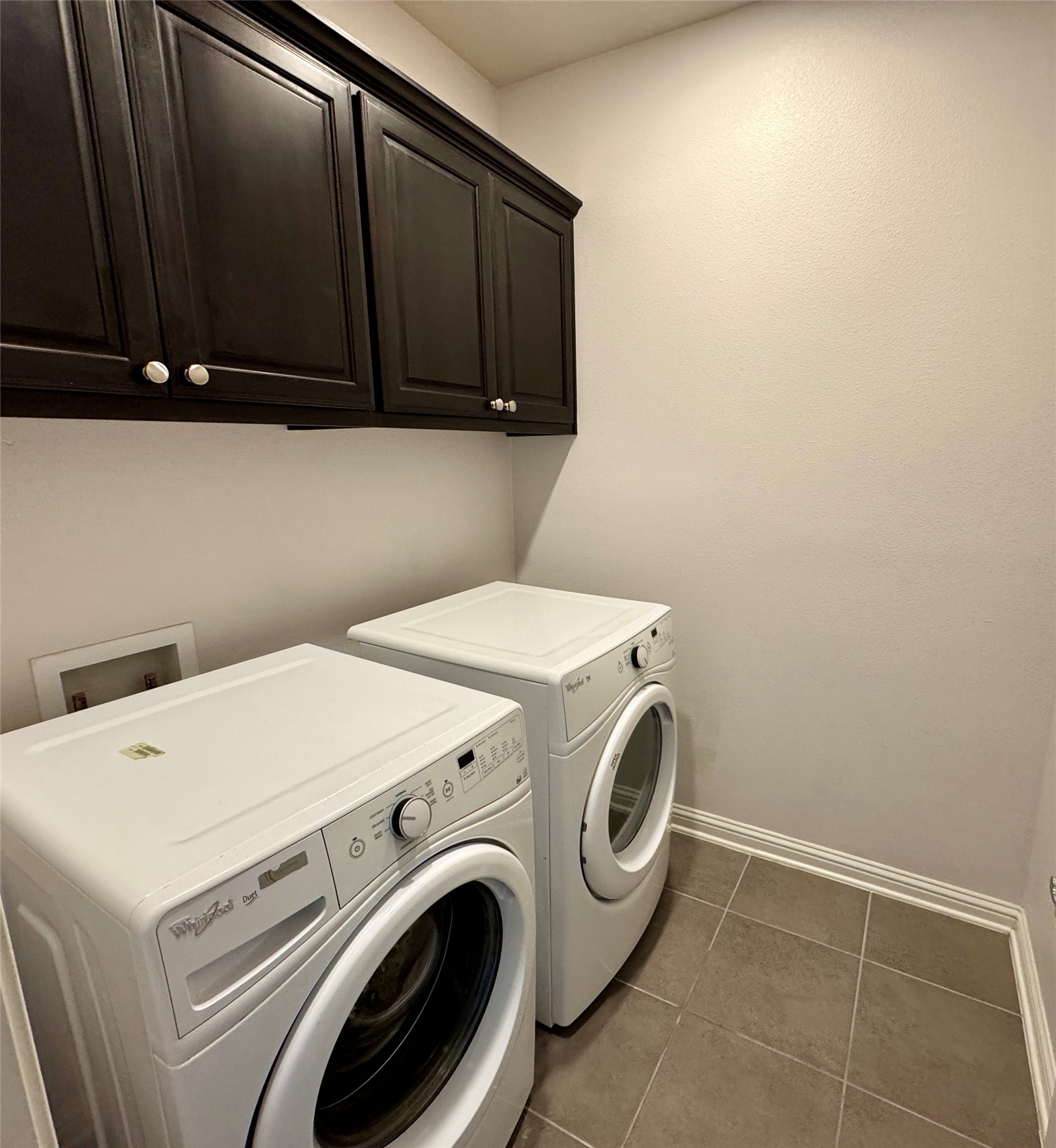 6814 East Riverside Drive, Unit 25 Austin, TX 78741 - Photo 19 of 26 Laundry room featuring dark tile patterned floors, cabinet space, and independent washer and dryer