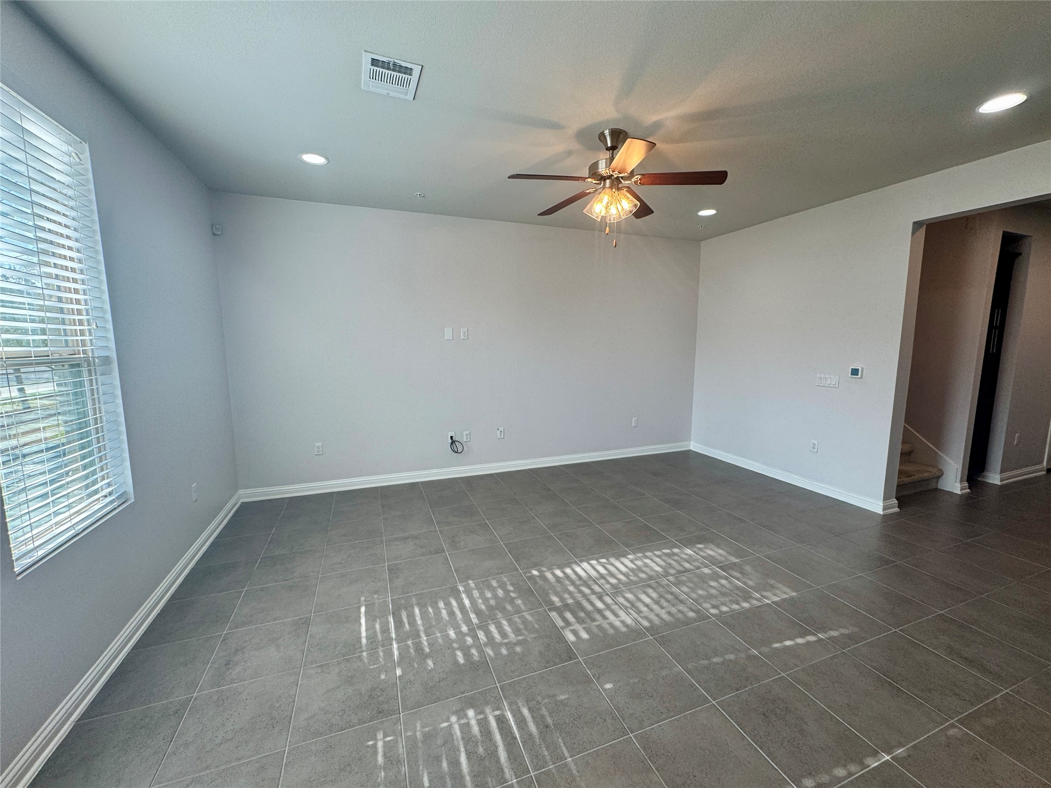 6814 East Riverside Drive, Unit 25 Austin, TX 78741 - Photo 2 of 26 Unfurnished room with dark tile patterned floors, ceiling fan, and recessed lighting