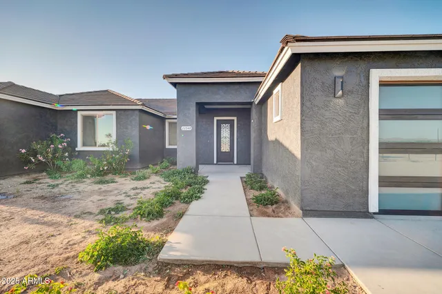 a front view of a house with garden