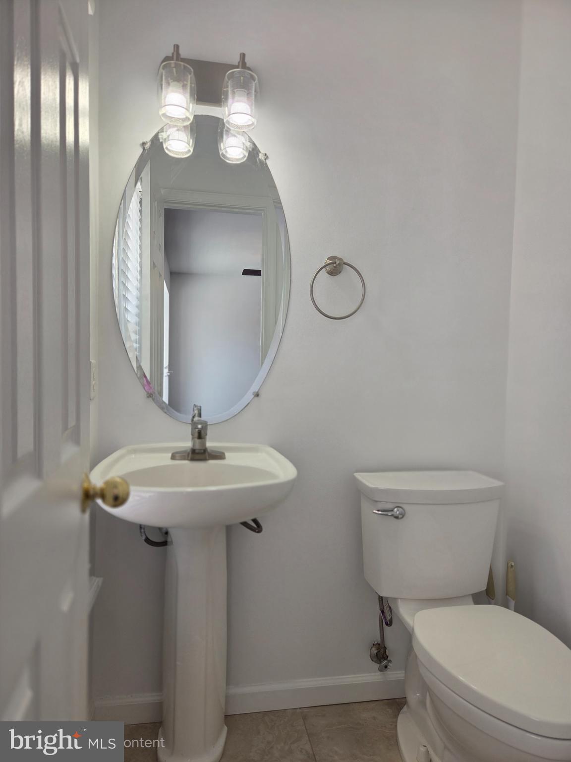 17381 Sligo Loop Dumfries, VA 22026 - Photo 12 of 35 a bathroom with a toilet a sink and mirror
