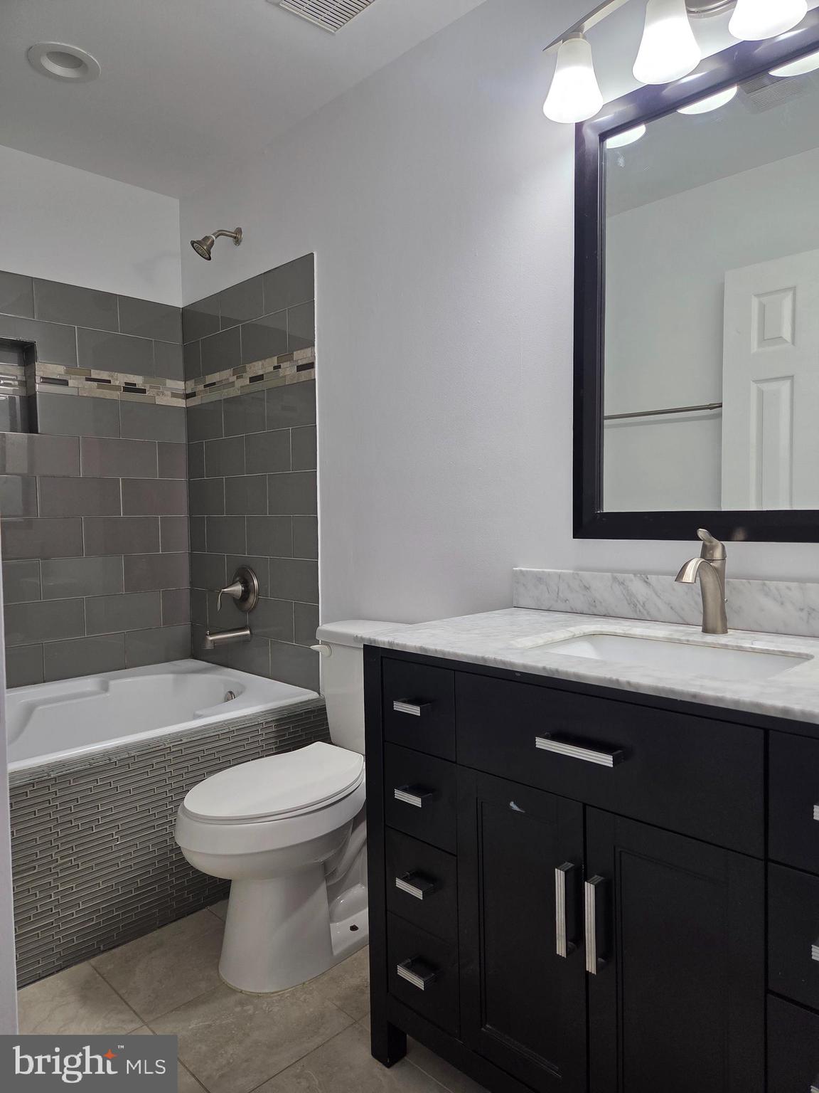 17381 Sligo Loop Dumfries, VA 22026 - Photo 16 of 35 a bathroom with a sink a toilet and shower