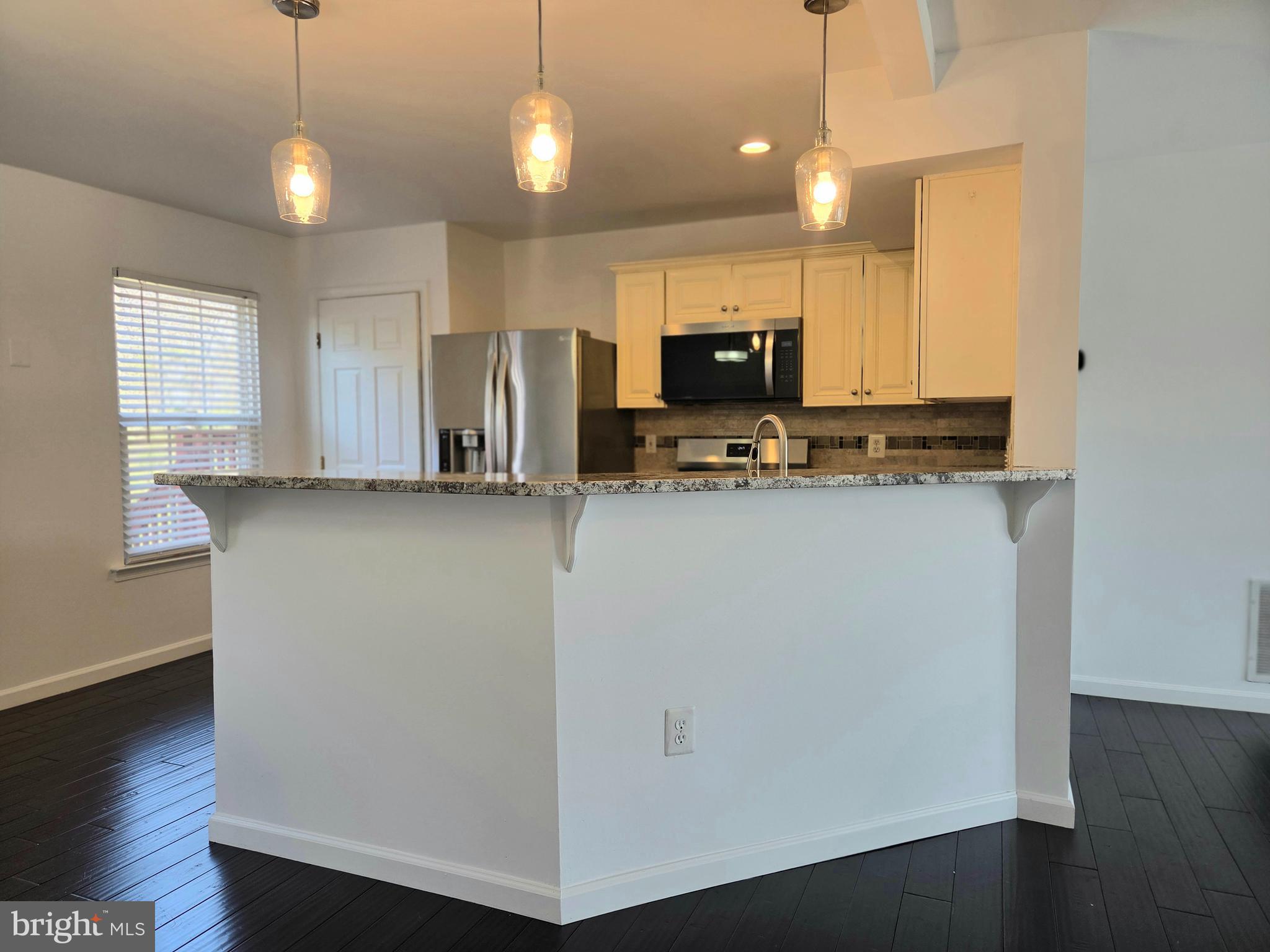 17381 Sligo Loop Dumfries, VA 22026 - Photo 2 of 35 a kitchen with stainless steel appliances a refrigerator sink and microwave
