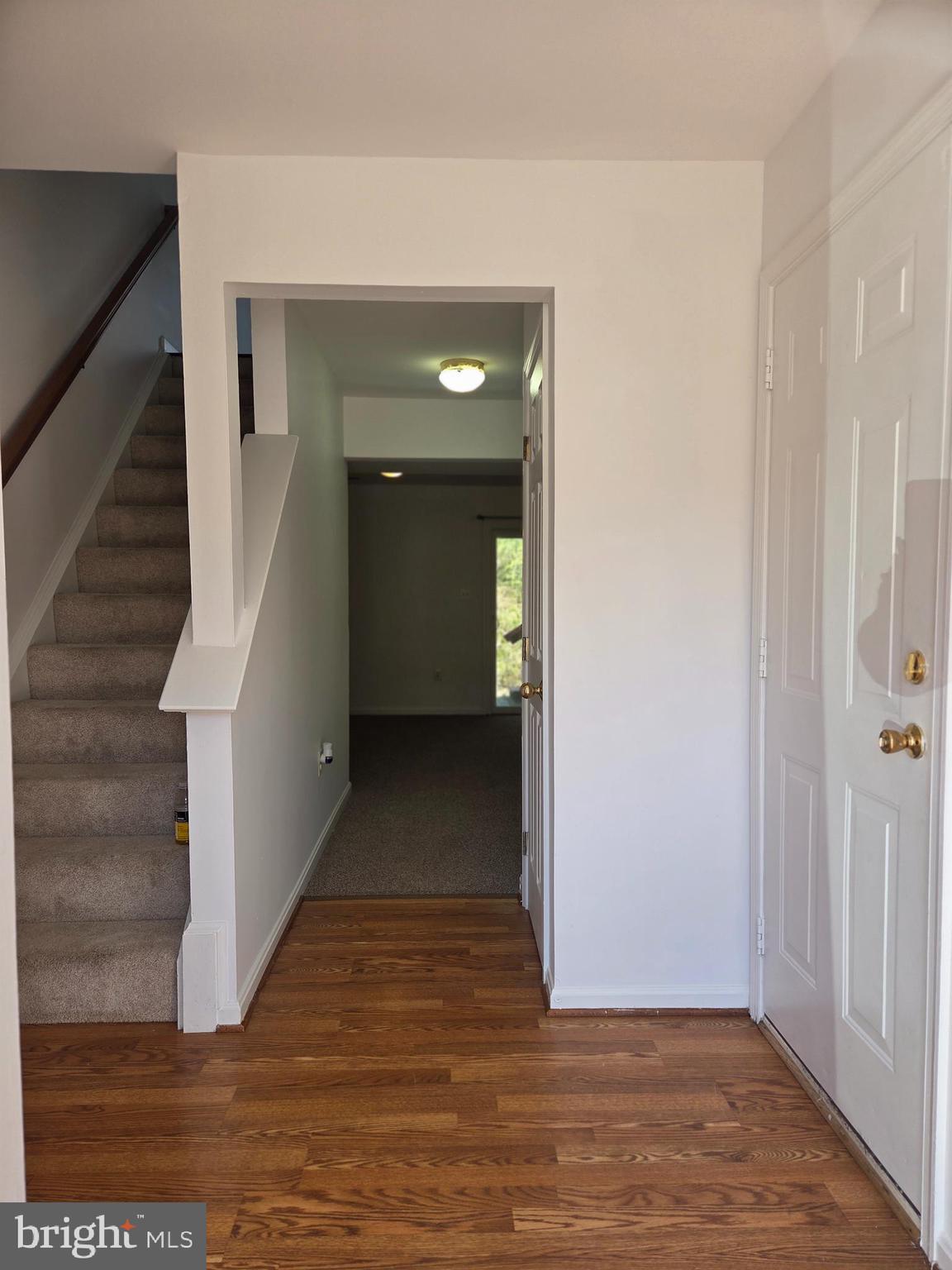 17381 Sligo Loop Dumfries, VA 22026 - Photo 23 of 35 a view of a hallway with wooden floor and staircase