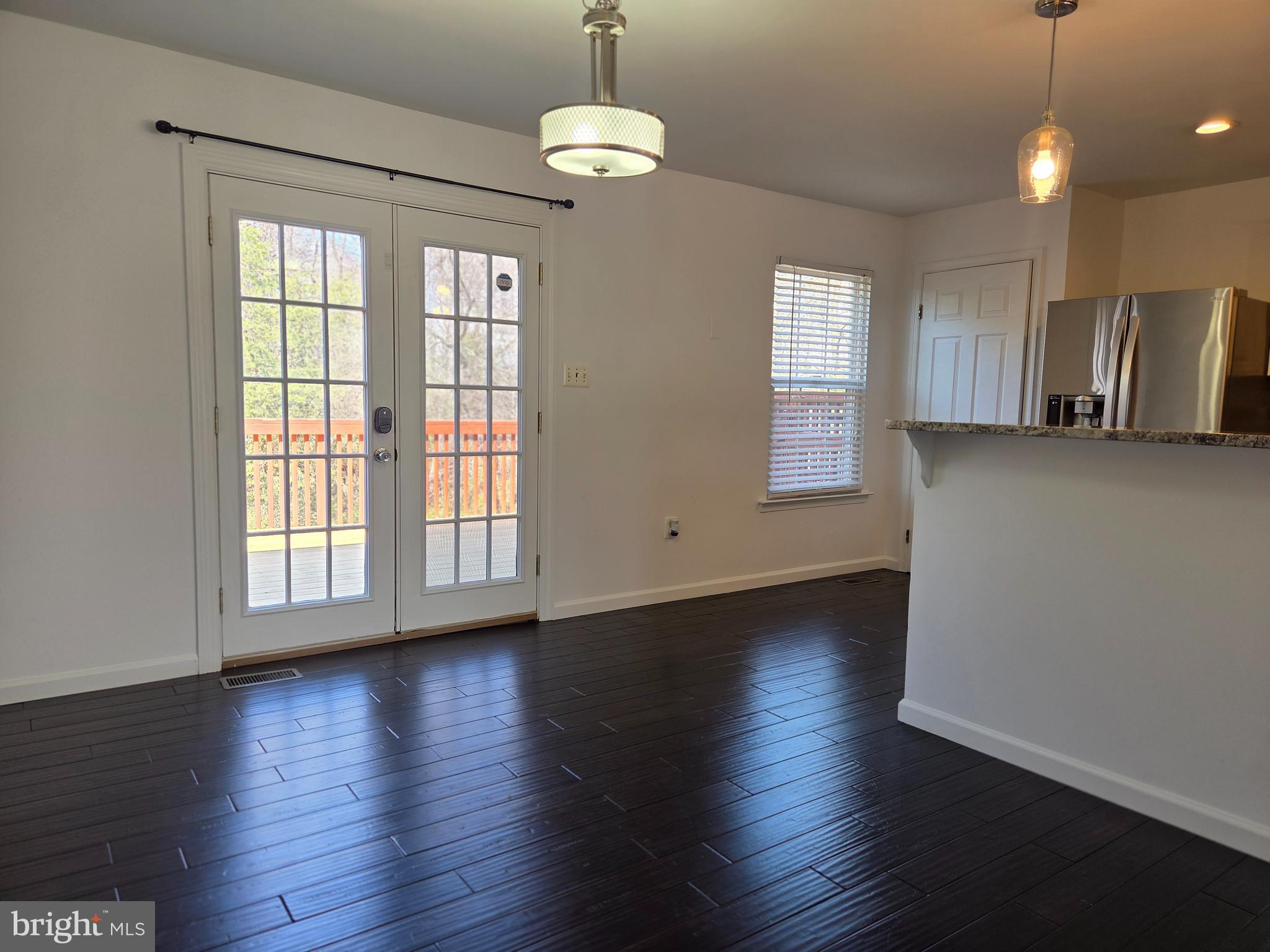 17381 Sligo Loop Dumfries, VA 22026 - Photo 6 of 35 a view of an empty room with wooden floor and a window