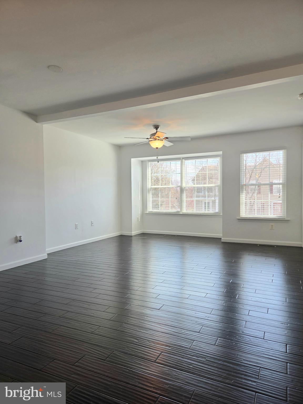 17381 Sligo Loop Dumfries, VA 22026 - Photo 9 of 35 wooden floor in an empty room with windows
