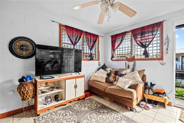 a living room with furniture a rug and a window
