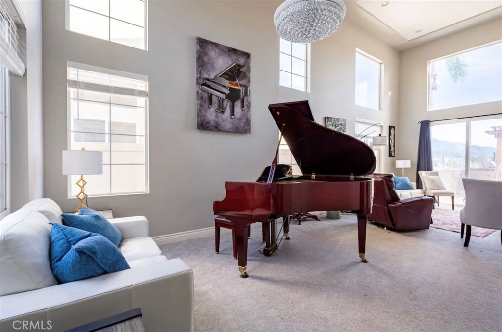 a living room with furniture a window and a piano table