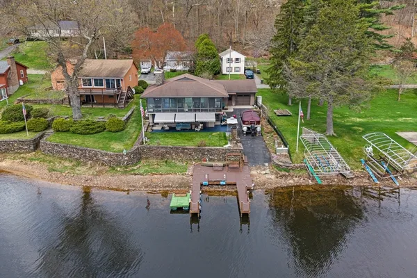 an aerial view of a house with yard swimming pool and outdoor seating