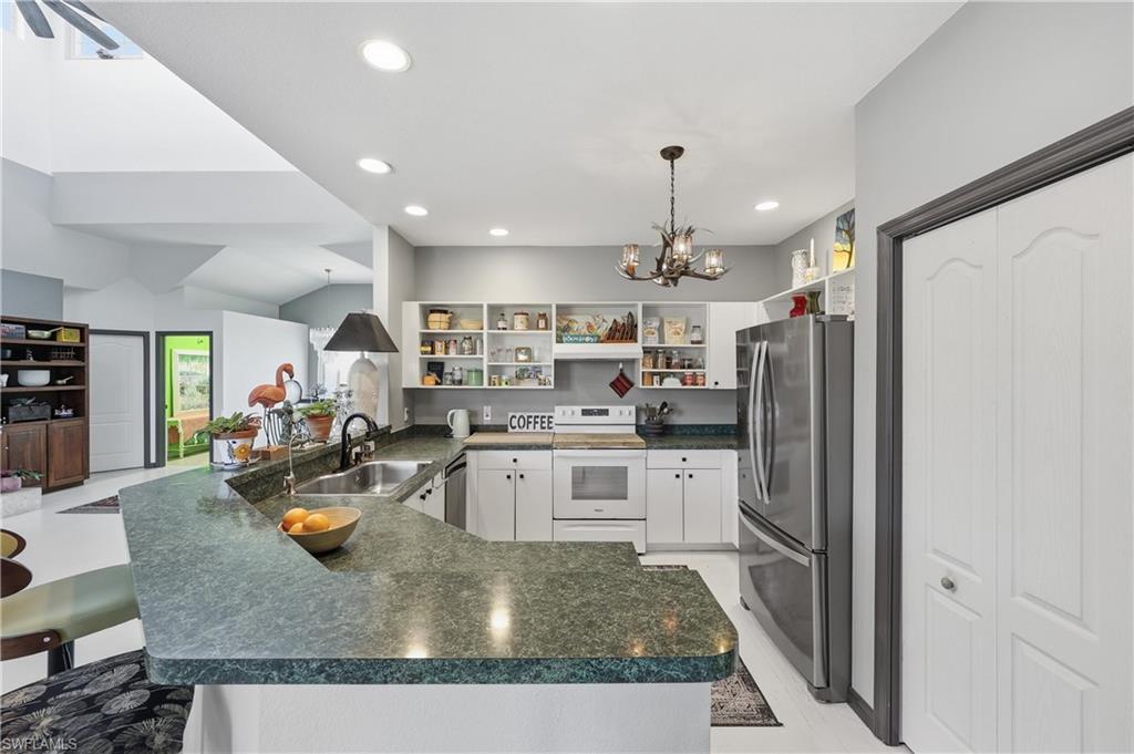 2958 Poplar Street Naples, FL 34112 - Photo 9 of 49 a kitchen with stainless steel appliances granite countertop a refrigerator a stove and a sink
