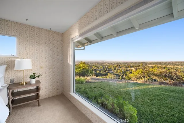 a view of a room with a bed and a floor to ceiling window
