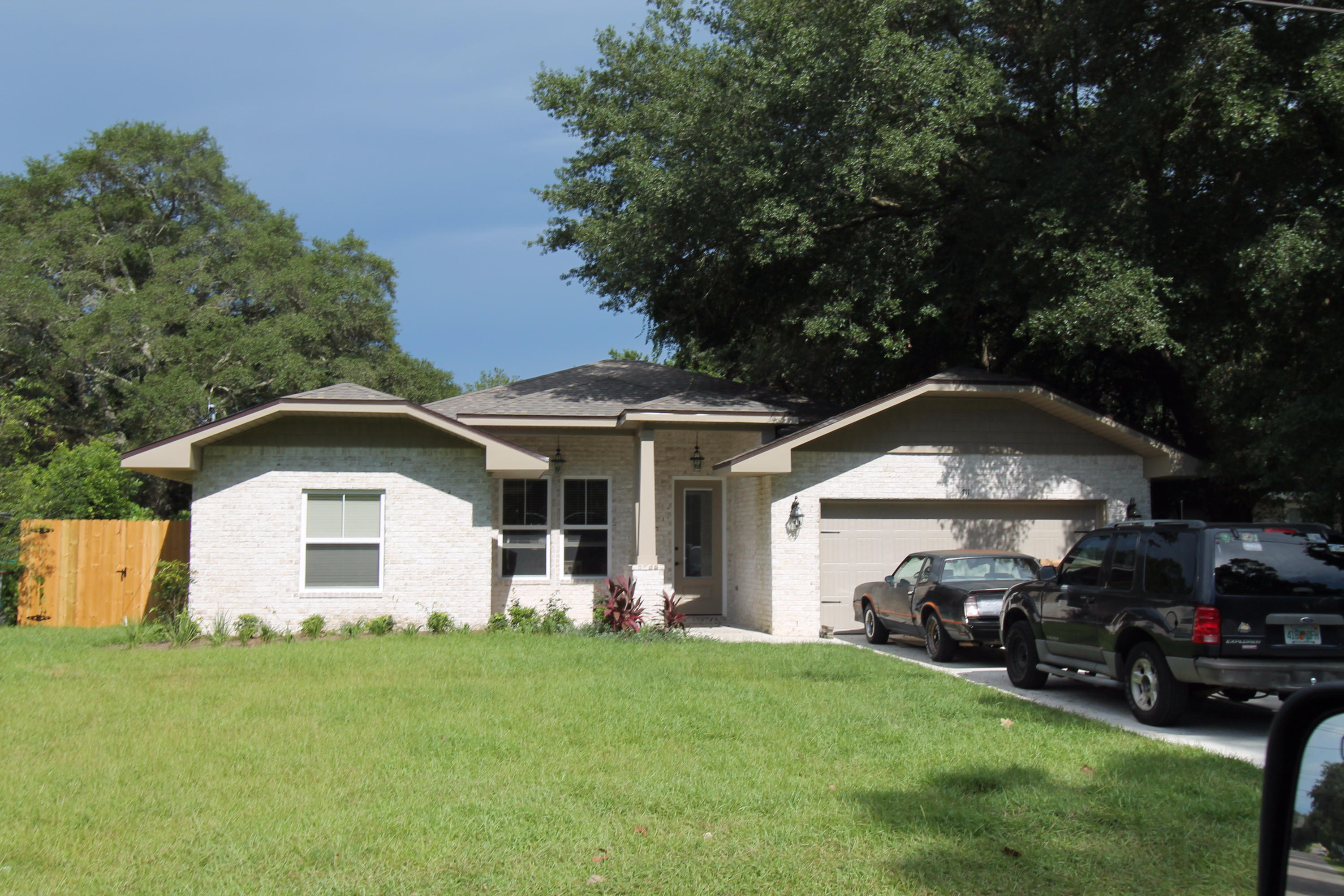 a front view of a house with a garden