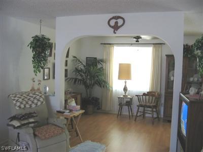 9177 Seville Road Fort Myers, FL 33967 - Photo 3 of 6 a living room with furniture and a chandelier