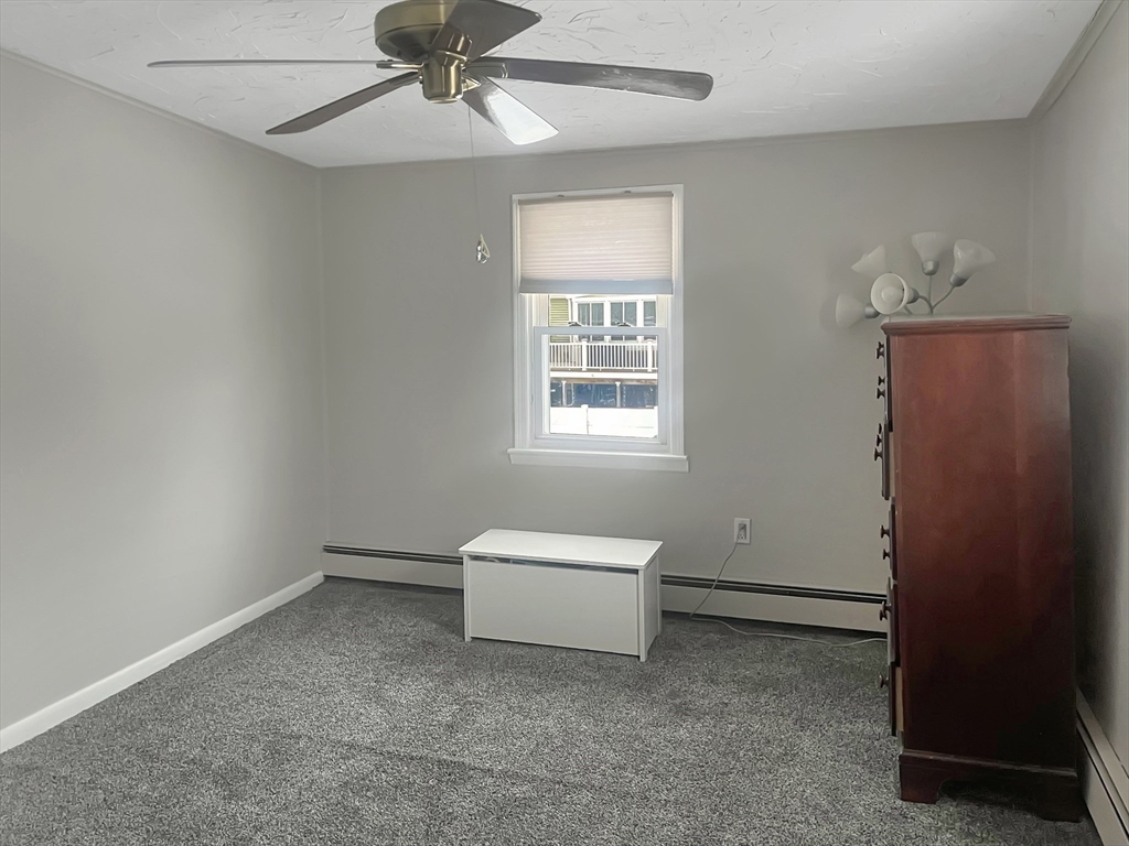 8 Flint Street Chelmsford, MA 01824 - Photo 12 of 20 a living room with a window and a chandelier
