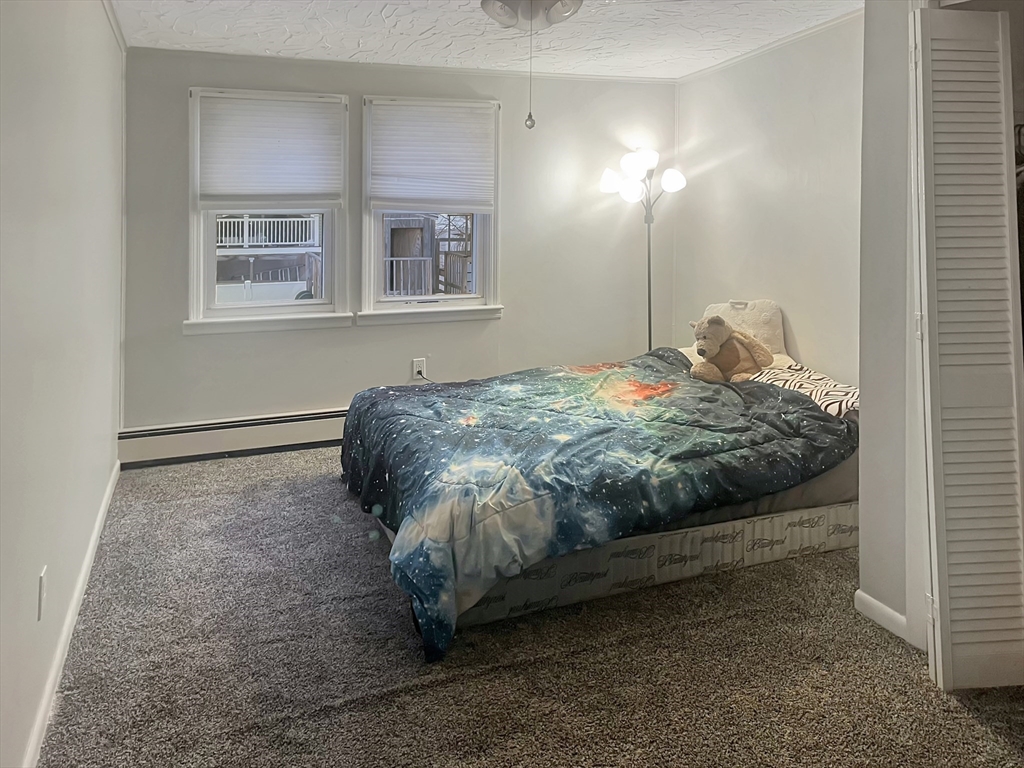 8 Flint Street Chelmsford, MA 01824 - Photo 13 of 20 a bed sitting in a bedroom next to a window
