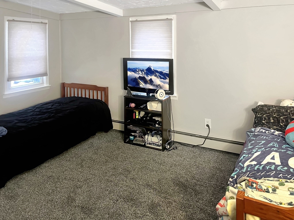 8 Flint Street Chelmsford, MA 01824 - Photo 14 of 20 a bedroom with a bed and a window