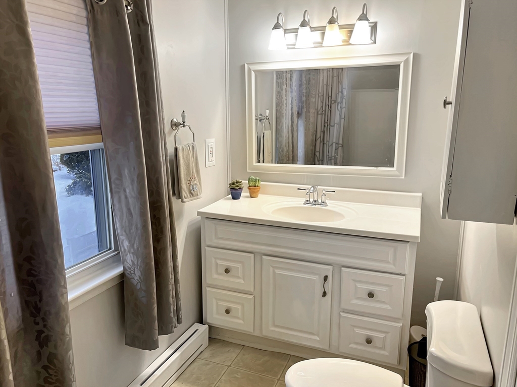 8 Flint Street Chelmsford, MA 01824 - Photo 15 of 20 a bathroom with a sink a toilet and mirror