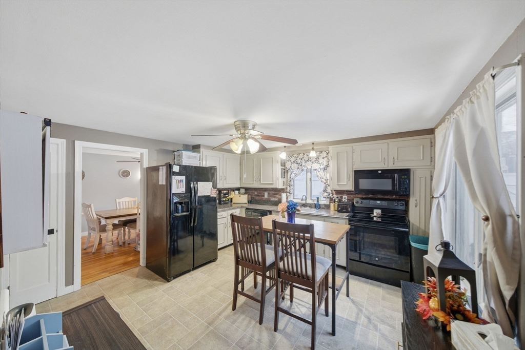 8 Flint Street Chelmsford, MA 01824 - Photo 2 of 20 a view of a dining room with furniture and a kitchen